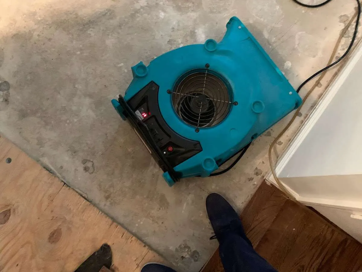 Air mover drying subfloor during Commercial Water Damage Restoration in Fountainhead-Orchard Hills